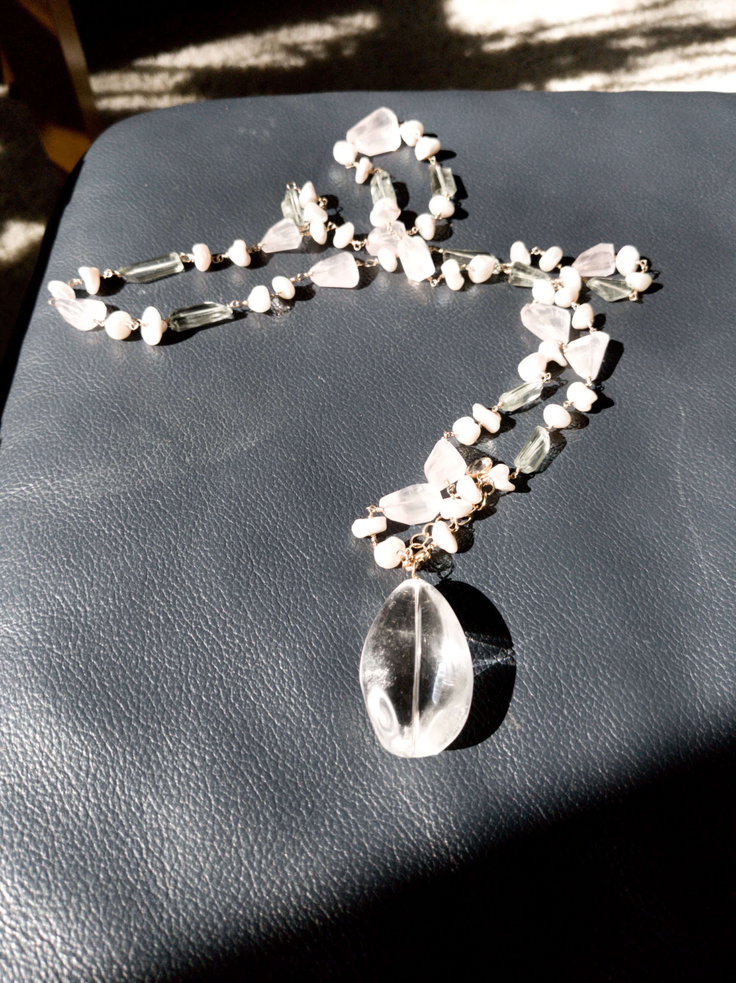 Rose quartz and pale green stone necklace with a large clear quartz drop pendant