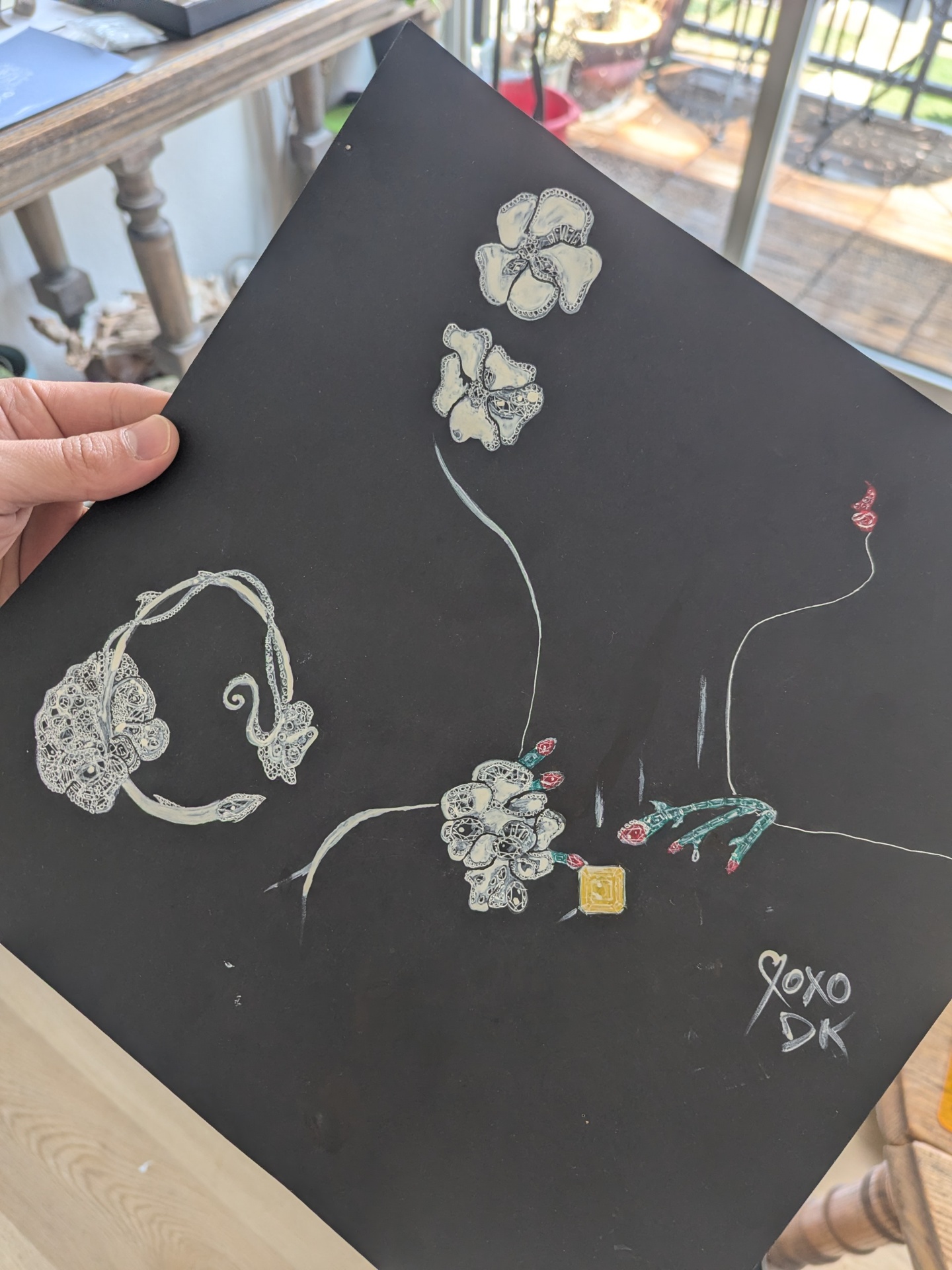 Full jewelry design sketch on black paper — orchid earrings, cuff, and gem-set ring