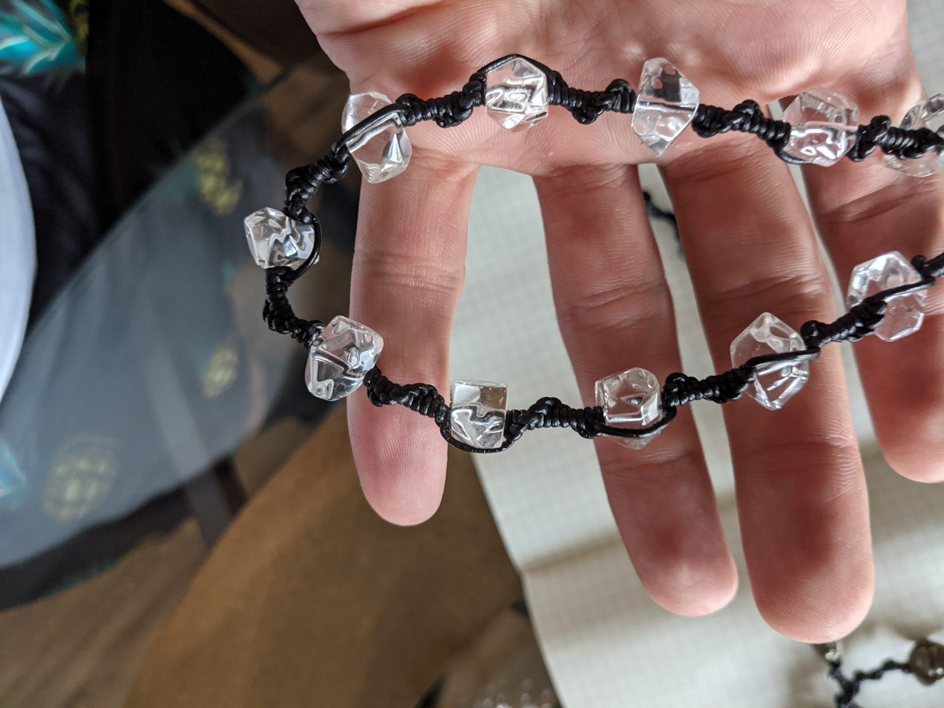 Detail of black macramé knotting with clear quartz crystal beads