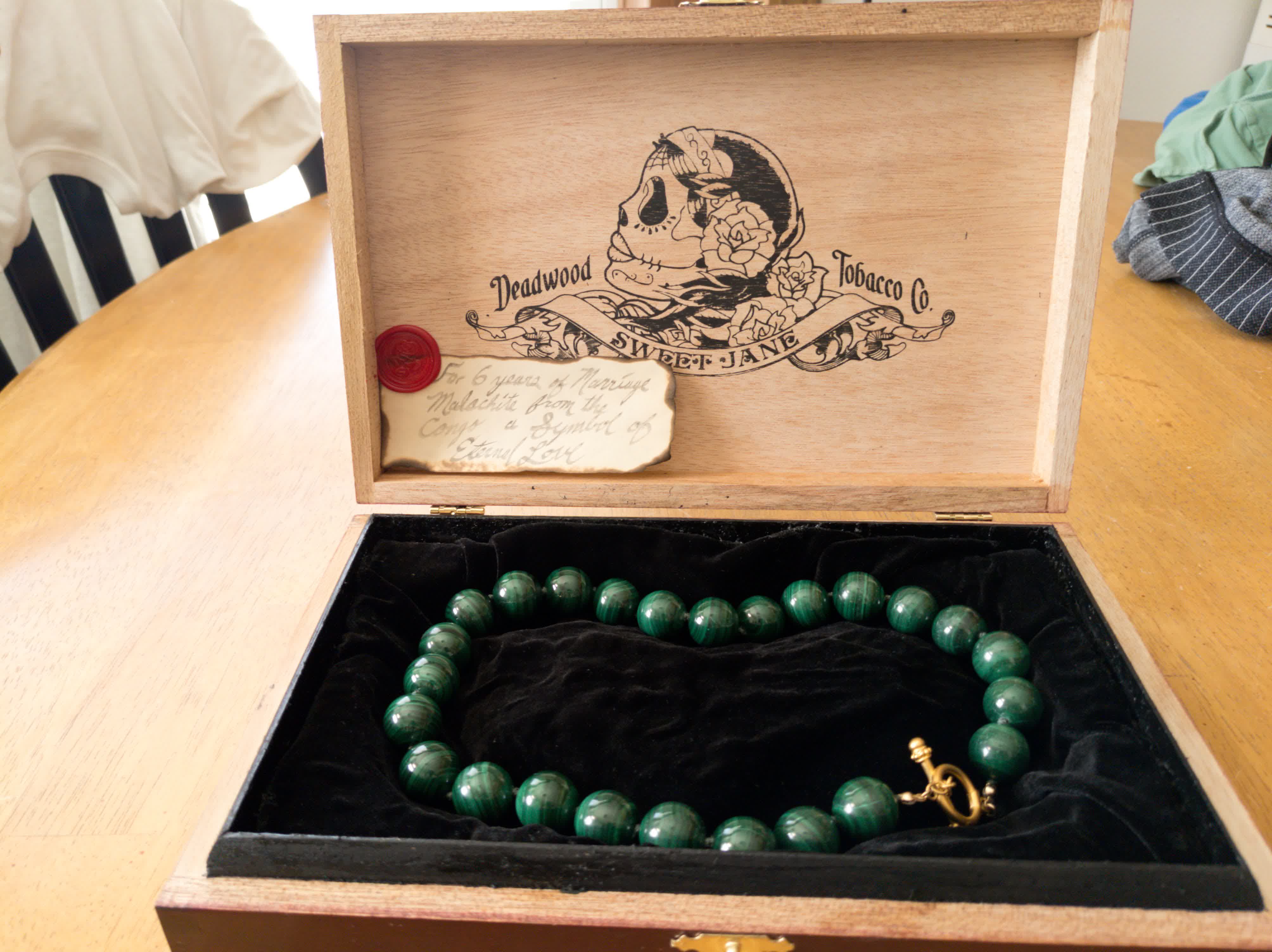 Malachite bead necklace presented inside a keepsake box lined with black velvet