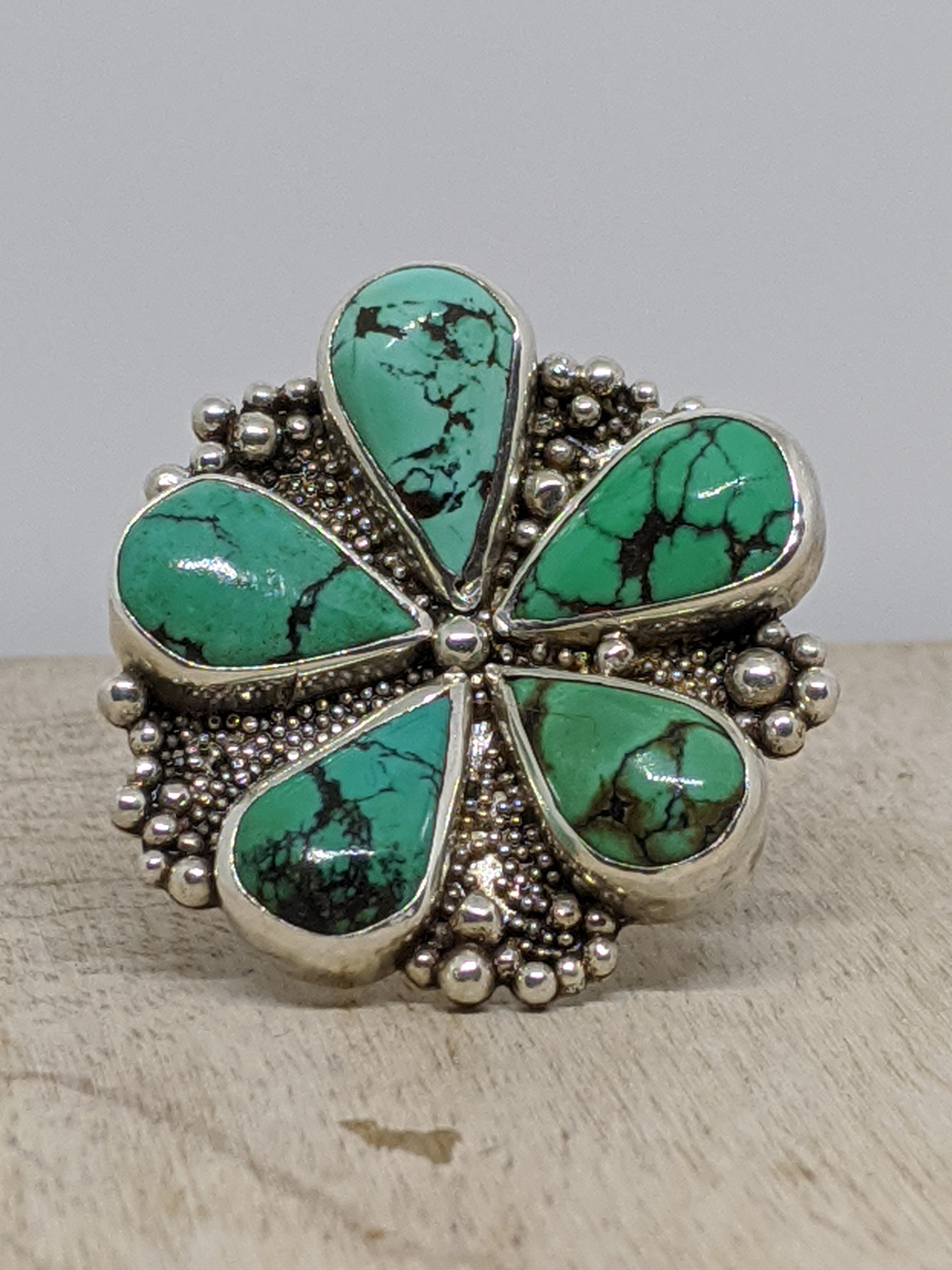 Sterling silver ring with six turquoise teardrop cabochons and granulation