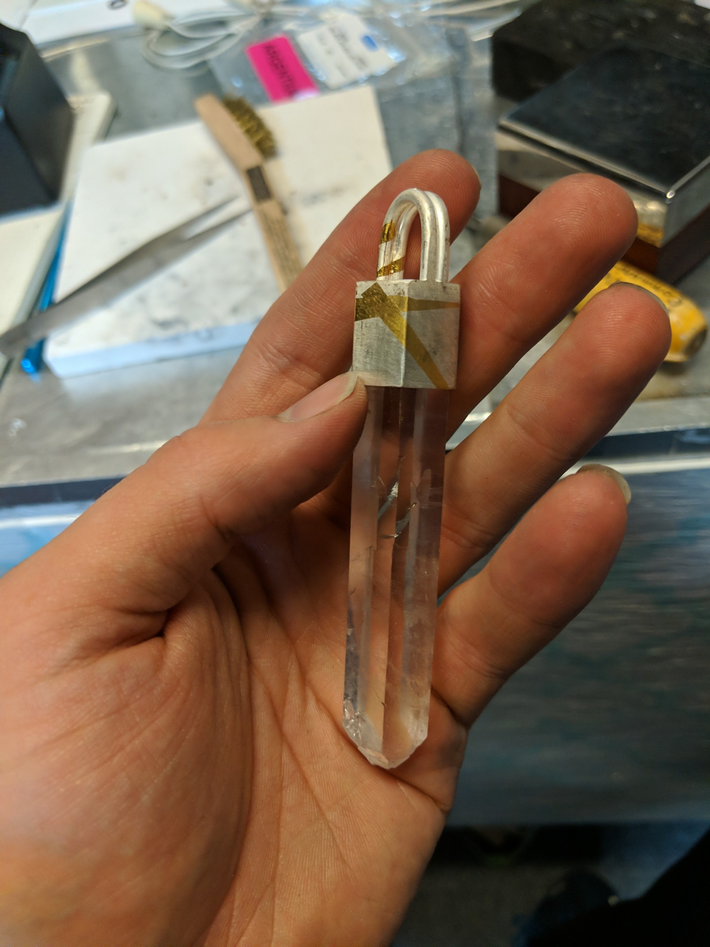 Early crystal point pendant capped with a geometric silver-and-gold top