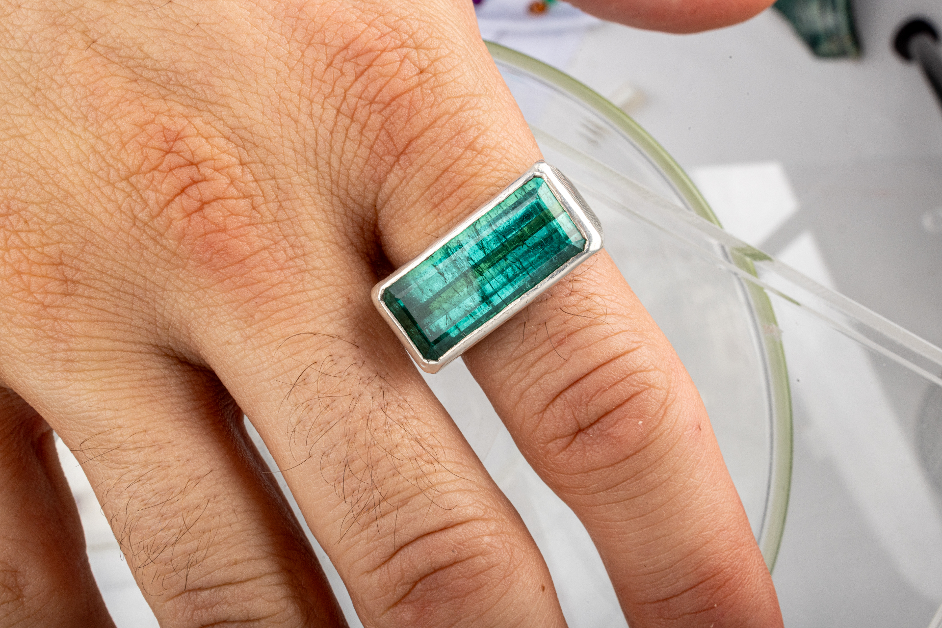 Sterling silver ring with a large emerald-cut blue-green tourmaline center stone